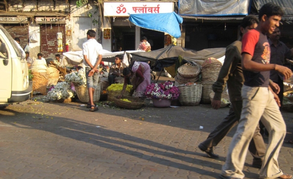 Men pass by the Dadar flower market in Mumbai. (Angeline Thangaperakasam and Michael Newbill/Asia Society India Centre)