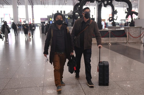 Wall Street Journal reporters Philip Wen (L) and Josh Chin (R) departing China in February
