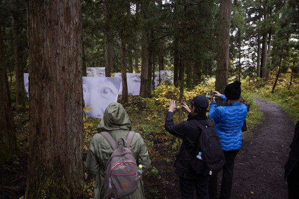 Participants viewing Christian Boltanski’s “Forest Spirit” (Russia) in the woods