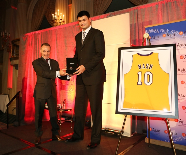From left, Jean-Marc Bories, International Sales Director Girard-Perregaux presents a watch to Yao Ming, honored as "Visionary of the Year" during the Asia Society Southern California 2013 Annual Gala held at the Millennium Biltmore Hotel on Tuesday, February 19, 2013 in Los Angeles, Calif. (Photo by Ryan Miller/Capture Imaging)