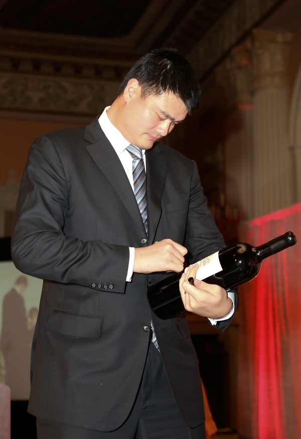 Yao Ming, honored as "Visionary of the Year" autographs a bottle of his Yao Family Wine during the Asia Society Southern California 2013 Annual Gala held at the Millennium Biltmore Hotel on Tuesday, February 19, 2013 in Los Angeles, Calif. (Photo by Ryan Miller/Capture Imaging)