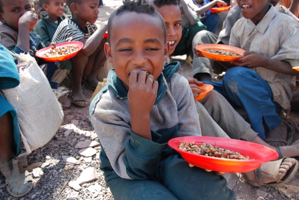 A child enjoys his meal in Koraro, Ethiopia, where Table for Two works with the local organization Millenium Promise to provide meals. (Table for Two)