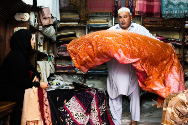 The photographer's cousin picks out shawls for her fashion design business. (Nushmia Khan)