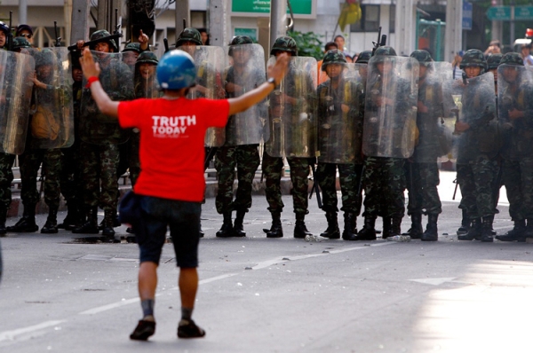 A &quot;Red Shirt&quot; protester approached members of the Thai military during violent protests in Bangkok, Thailand on Apr. 13. Assembled in the heart of Bangkok to demand public reforms and new elections, the Red Shirts were ultimately dispersed in a violent state crackdown that has left lingering rifts in Thai society. (Paula Bronstein/Getty Images)