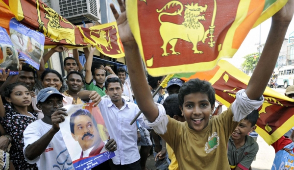SRI LANKA, MAY 19 - Colombo residents celebrate on the day Sri Lanka&apos;s president proclaimed victory over the Tamil Tigers after decades of civil war. (Ishara S. Kodikara/AFP/Getty Images)