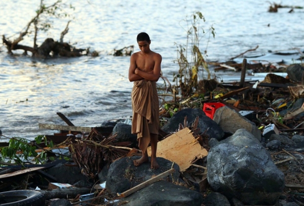 AMERICAN SAMOA, SEPTEMBER 30 - A man surveys the devastation left by the tsunami that swept across areas of the island, destroying entire villages and killing more than 100 people. (Phil Walter/Getty Images)