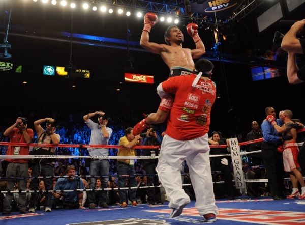 UNITED STATES, NOVEMBER 14 - Manny Pacquiao of the Philippines celebrates after defeating Miguel Cotto of Puerto Rico during their WBO welterweight title fight at the MGM Grand in Las Vegas. (Gabriel Bouys/AFP/Getty Images)