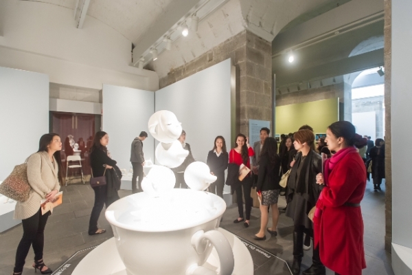 Guests viewing and discussing the sculpture of Yoshitomo Nara at the opening.