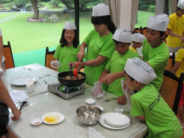 In cooking class, children help make &lt;i&gt;tteokbokki&lt;/i&gt;, a traditional Korean dish. (Asia Society Korea Center)