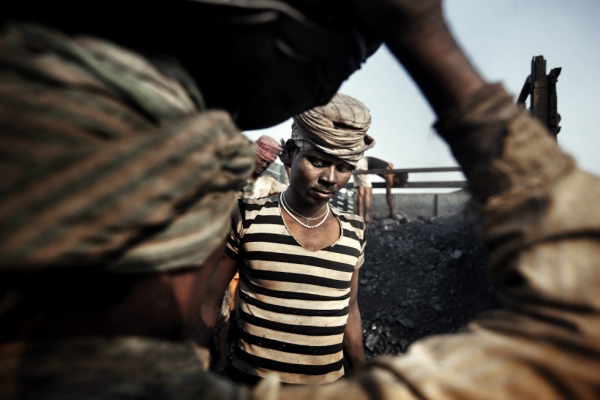 Miners prepare to load coal onto a truck. (Erik Messori)