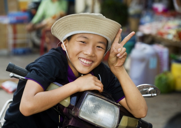 A friendly Vietnamese boy stops his bicycle in Cao Lahn, Vietnam to offer a smile and a peace sign on February 22, 2010. (Nancy A. Scherl)