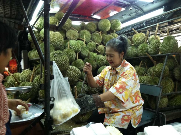 In Thailand, a street vendor selling the notoriously fragrant fruit known as durian. (Kavi Reddy)