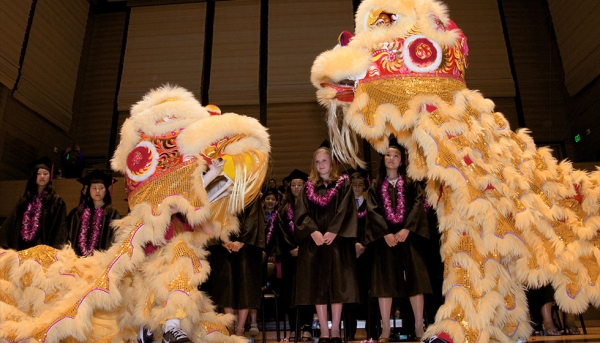 Student lion dancers perform and escort graduates following ceremony. (Chinese American International School)