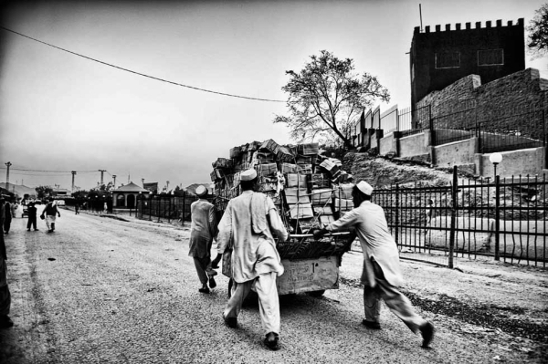 The Afghan half of Torkham is a one-road town that leads into Pakistan. The street bustles with humanity, chatter and trucks. (Suchitra Vijayan)
