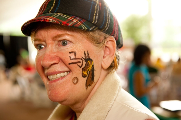 A festival participant shows off her zodiac sign, hand-painted by Vi Le (Jeff Fantich).