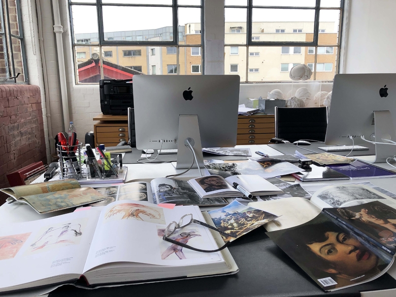 Books, research materials, and a computer in the studio of Reza Aramesh