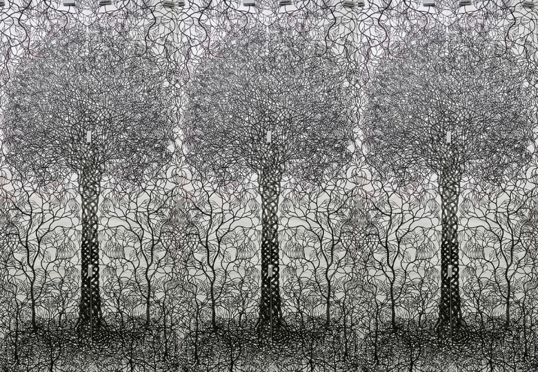 Three large, vertical sheets of paper are connected together; each features an intricately drawn tree with hundreds of interlaced branches and roots drawn in black. 