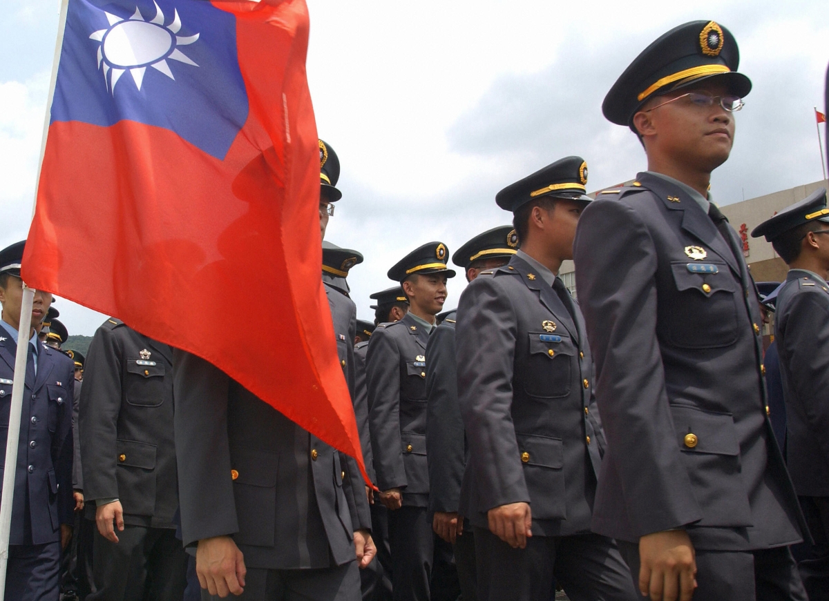 This photo shows cadets standing next to Taiwan's national flag during the joint graduation ceremony of five military academies in Taipei, 06 July 2007. This year some 700 cadets from the Air Force, the Navy and the Army academies were graduated. 