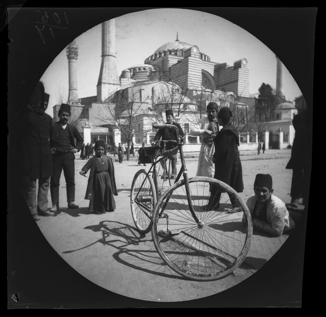 William Sachtleben’s Humber bicycle at rest in Constantinople draws a crowd of spectators.  Background: Hagia Sophia and Thomas Allen on his bicycle.  March 21, 1891. Collection of the UCLA Library Special Collections