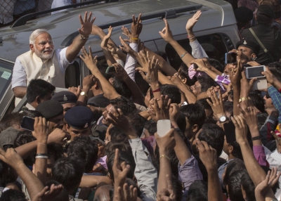 BJP leader Narendra Modi waves to supporters after voting at a polling station on April 30, 2014 in Ahmedabad, India. (Kevin Frayer/Getty Images)