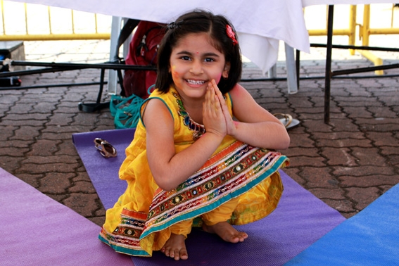 A young girl in a yoga pose at the storytelling session by Kids Yoga instructors from Urban Ashram (Photo Credit: Andressa Flores)