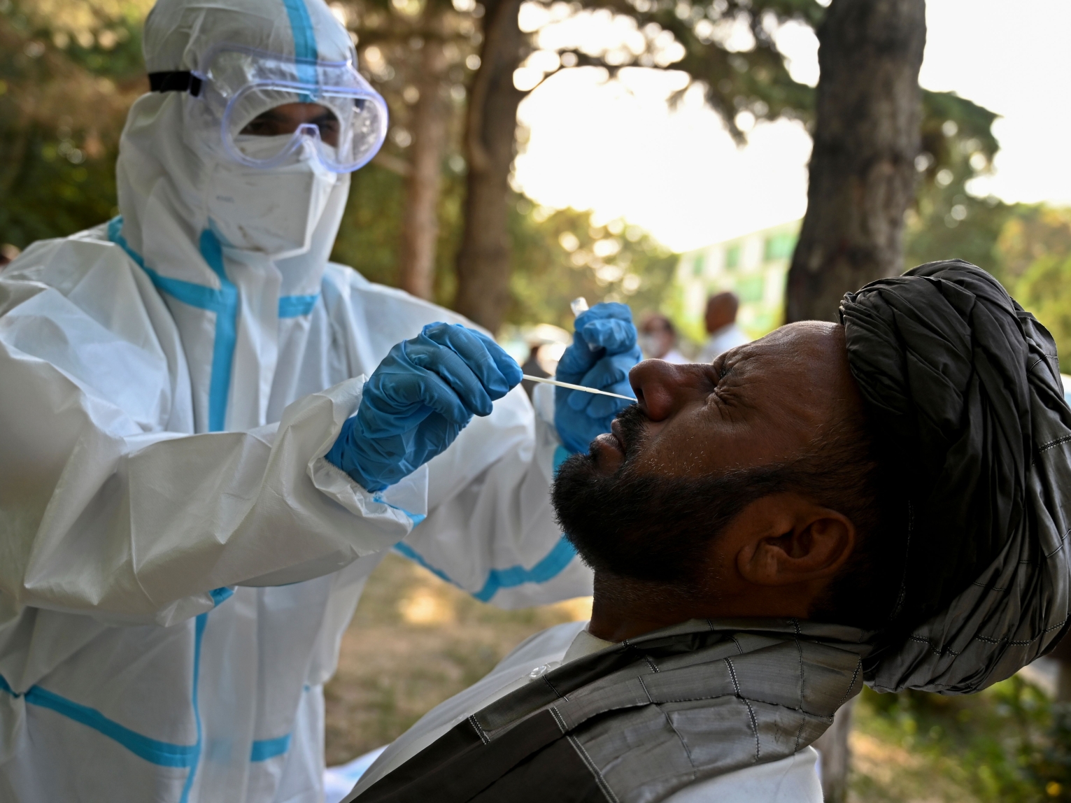 An Afghan man is tested for COVID-19